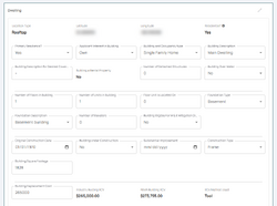 A large clock tower and other buildings line a great river.